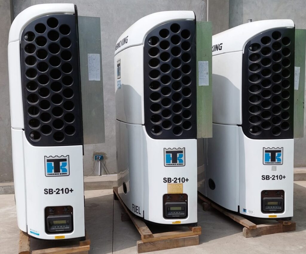 Three Thermo King trailer refrigeration units labelled SB-210+ standing on pallets